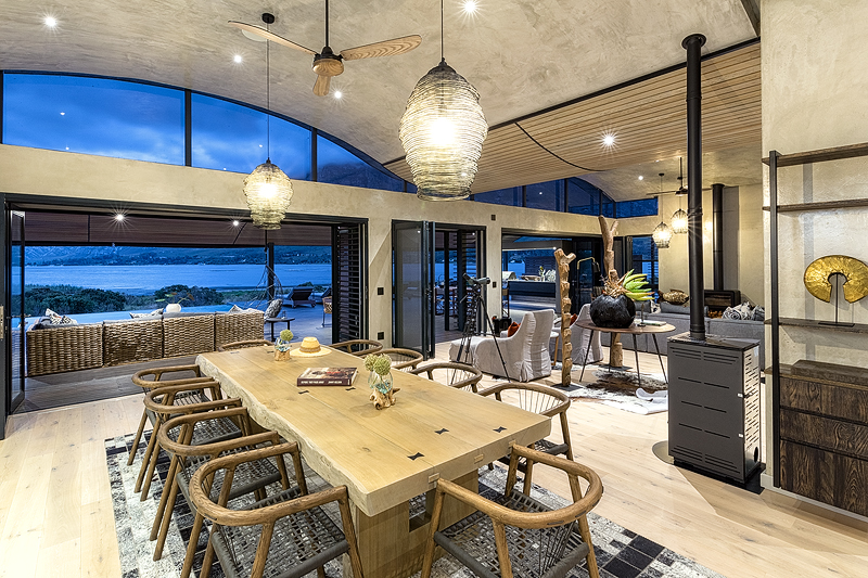 <p>LIVING AND DINING<br /> The open plan lounge and dining room has with wide glass doors and windows overlooking the Lagoon and is<br /> equipped with ceiling fans, underfloor heating, a wood-burning fireplace and eco-friendly pellet stoves.<br /> The rooms are decorated with sympathetically and sustainably sourced stylish unique African artefacts with<br /> explanations of their provenance provided and with pictures by local up-and-coming artists.<br /> &ndash; Main lounge open plan leads onto kitchen and large dining area<br /> &ndash; Dining area for 10 guest<br /> &ndash; Free-flowing entertainment and living areas<br /> &ndash; Wood combustion and eco fireplaces in living the room provide a gracious retreat on chilly evenings.<br /> &ndash; Inside and outside living areas are equipped with a state-of-the-art eight speakers four-zoned SONOS<br /> wireless audio system to play the music of your choice effortlessly from your phone or tablet / iPad.<br /> &ndash; Big glass doors and windows allow natural light flood into the house<br /> &ndash; Celling fans, underfloor heating in main and dining areas<br /> &ndash; Spacious entertainment areas, outdoor living and private heated rim-flow pool<br /> KITCHEN<br /> &ndash; The House is equipped with a fully interactive, designer kitchen with a separate scullery room and<br /> laundry room.<br /> &ndash; Fully equipped Interactive designer kitchen with the latest kitchen equipment<br /> &ndash; A small decorative herb garden providing fresh ingredients for the kitchen is available for guest&rsquo;s use</p>