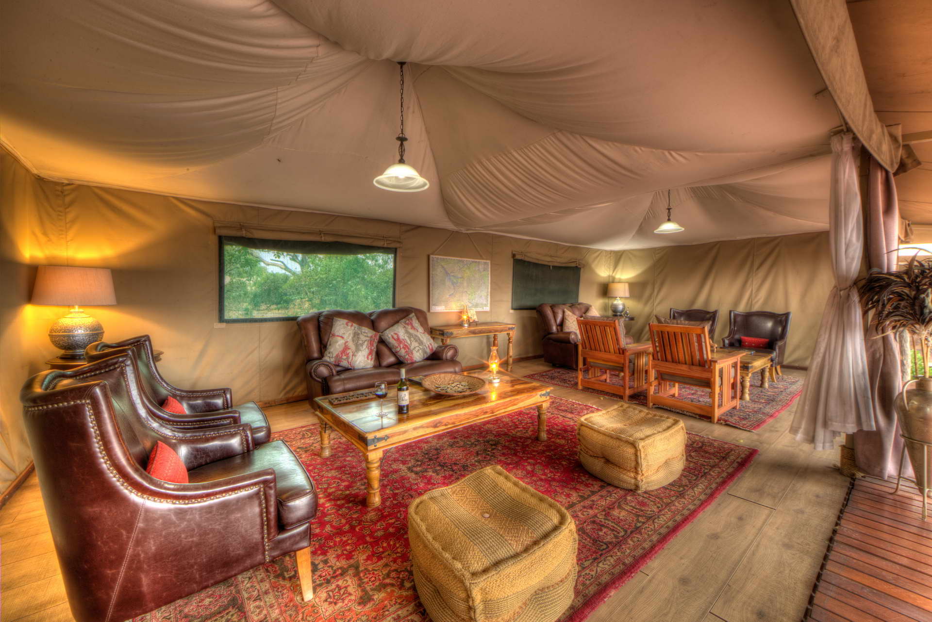 <p>Meru-style tents form the common area and open onto a central deck and fire pit.</p>  <p>The bar at Kadizora Camp is on a raised deck with a panoramic view of the floodplain. Enjoy a picturesque Delta sunset, with your favourite sundowner, watching the colours intensify long after the sun has set.</p>  <p>The inviting camp fire is the focal point from dawn to dusk, and it is the perfect place to chat about the day&rsquo;s adventures.</p>  <p>Tea / coffee facilities are available in the dining tent.</p>